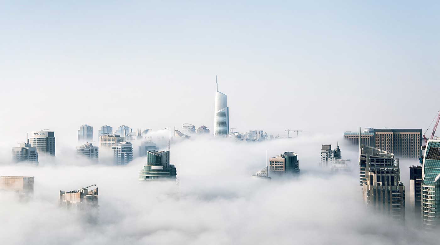 View of a high-rise skyline above the clouds