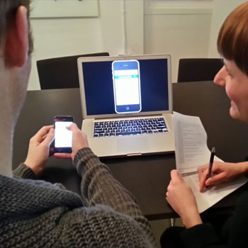 Two people testing a website on desktop and mobile devices