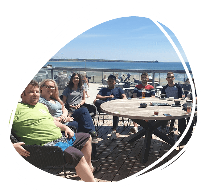 The Ireland Website Design team sitting around a table outside for lunch on a sunny day